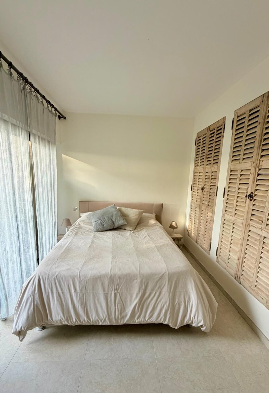 Bedroom with wooden shutters